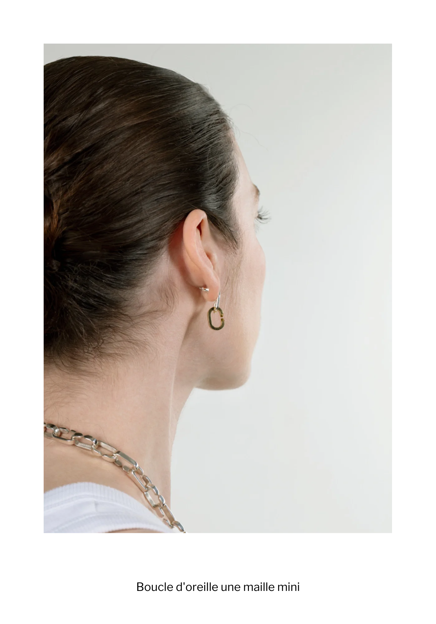 Femme de profil avec une boucle d'oreille composée d'une maille mini en or fairmined