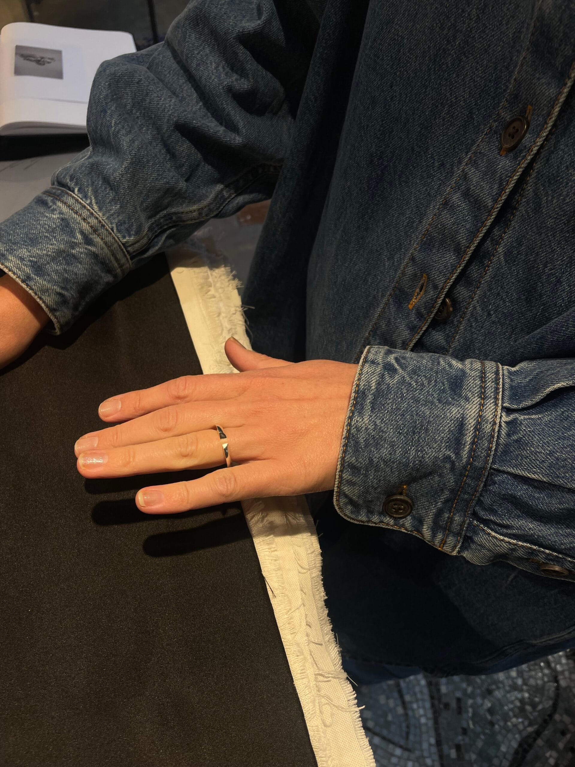 main portant une bague en argent labelisée fairmined